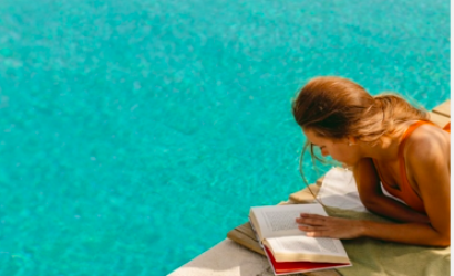 Leave your Kindle or tablet at home - because the book is back on holiday