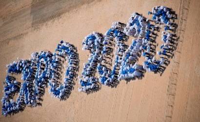 Students and volunteers form Dubai Expo 2020 logo