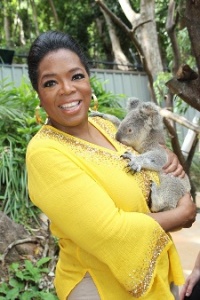 Oprah cuddles Elvis during her first Australian stop at Hamilton Island