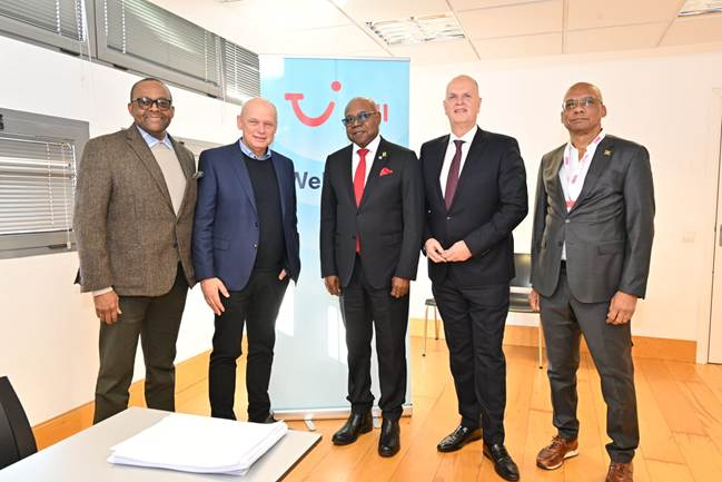 Pictured: Tourism Minister Edmund Bartlett (c) pauses with TUI Group CEO Sebastian Ebel (1st l) before a meeting to discuss how Jamaica and TUI Group can work together. The speakers are lr, Donovan White, director of tourism, Thomas Ellerbeck, director of external and corporate affairs of TUI Group and Gregory Shervington, regional director of continental Europe.